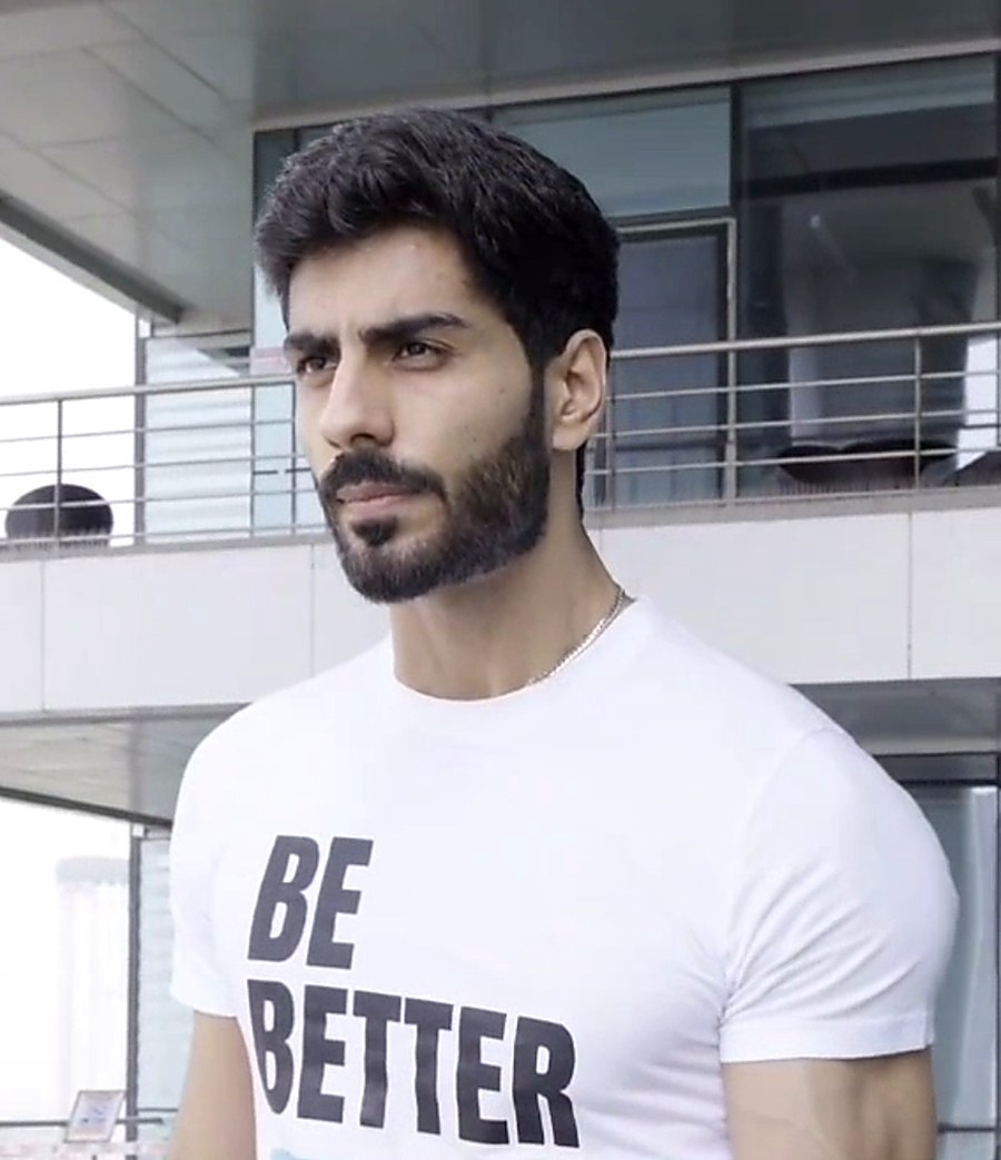 Jehan Sadri, online fitness and nutrition coach, wearing a BeBetter with Jehan t-shirt